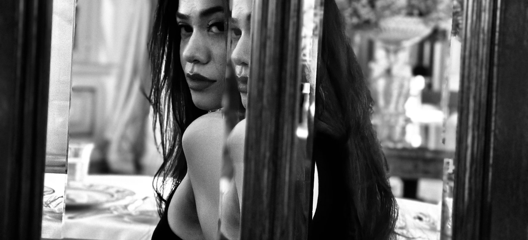 Simone reflected in a mirror, looking back